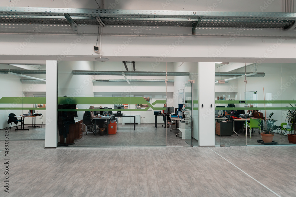 A modern glass office in the industry. Office with computers, tablets and modern devices. A modern glass office in the industry. Office with computers, tablets and modern devices.