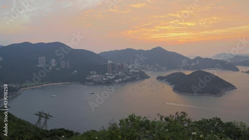 Time-lapse footage of the sky over view of Deep Water Bay, Hong Kong seen form brick hill (nam long shan) in sunrise time photo