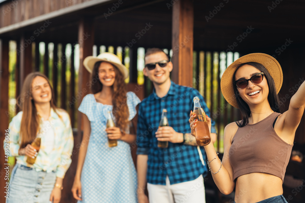 young friends making barbecue and drinking drinks, preparing meat in nature, having fun and taking selfie , youth lifestyle young friends making barbecue and drinking drinks, preparing meat in nature, having fun and taking selfie , youth lifestyle