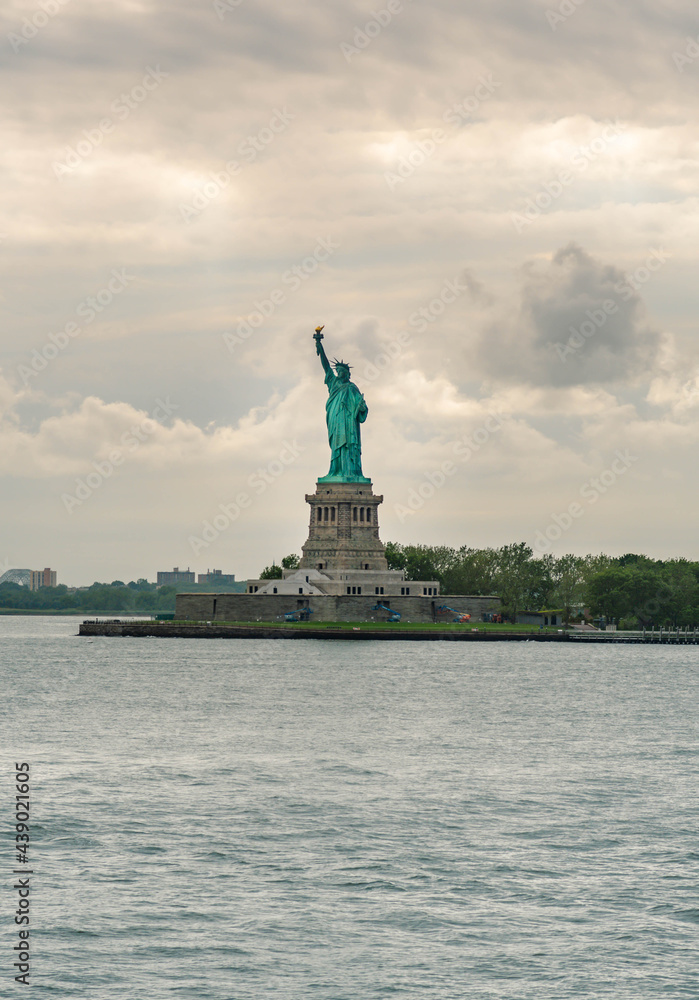 Ferry and Statue of Liberty , world famous travel destination composed with beautiful sky and clouds. Ferry and Statue of Liberty , world famous travel destination composed with beautiful sky and clouds.