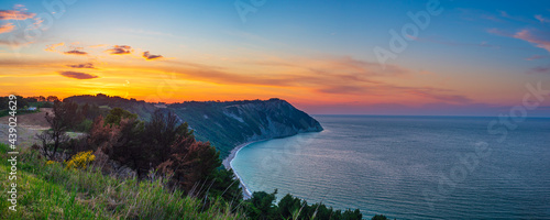 Sunset landscape Conero natural park dramatic coast headland rocky cliff adriatic sea beautiful sky colorful horizon, tourism destination Italy photo