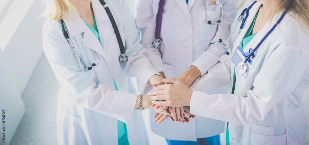 Doctors and nurses in a medical team stacking hands Doctors and nurses in a medical team stacking hands