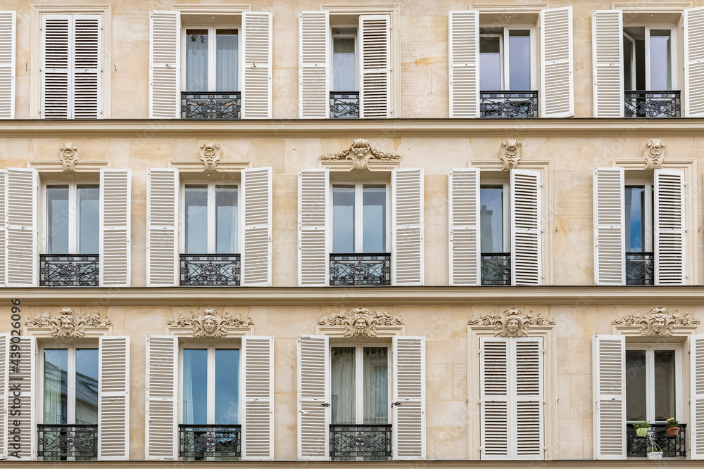 Paris, beautiful facade in the Marais, detail of the windows
