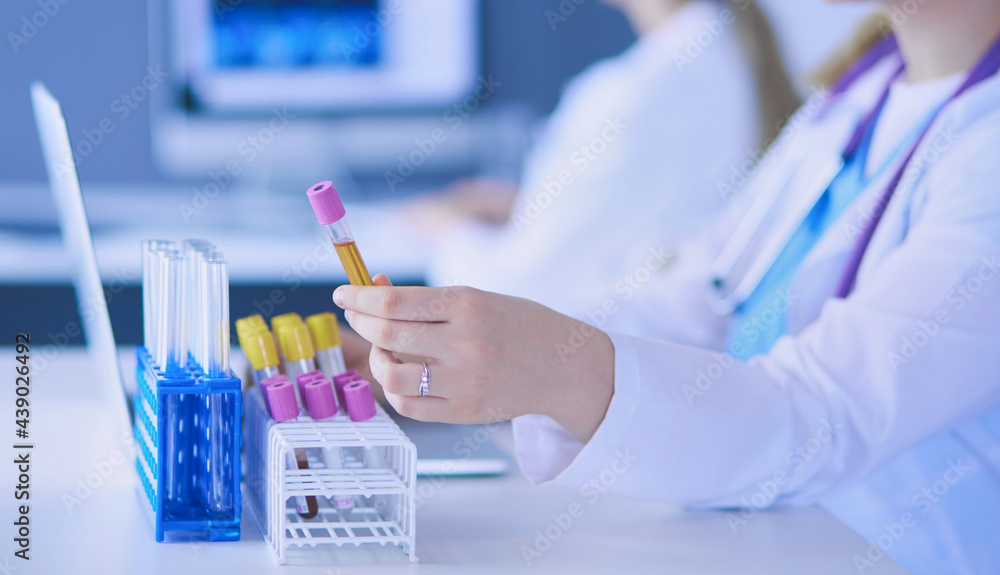 Two young female doctors at medical laboratory with tests. Two young female doctors at medical laboratory with tests.