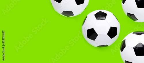 Soccer balls on green background. Top view