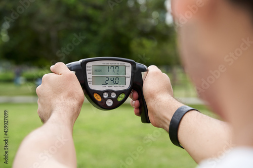  man in park grabbing a body fat monitor