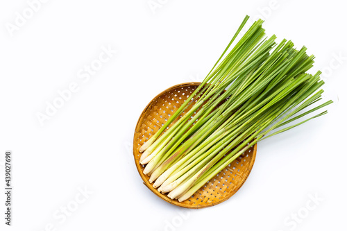 Fresh lemongrass in bamboo basket on white background. photo