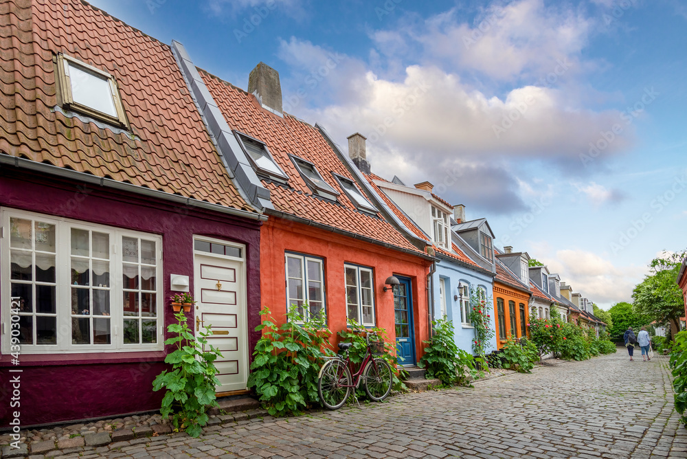 Aarhus, Denmark; June 12th, 2021 - Colourful old cottages on a quiet street in Aarhus, Denmark