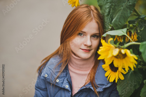 A girl on the background of sunflowers in autumn 2752.