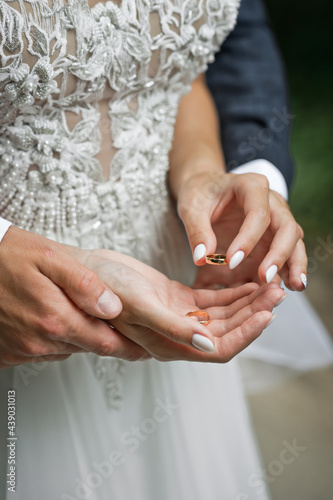 Hugs of newlyweds with wedding rings 2758.