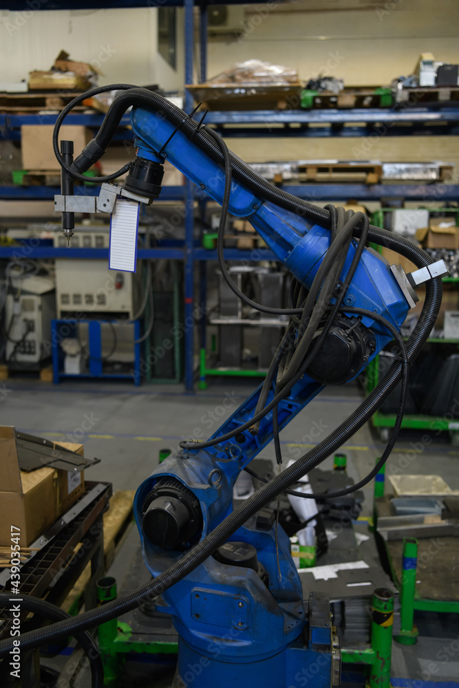 Automatic welding robot mechanical arm is working in the modern automobile parts factory. Automatic welding robot mechanical arm is working in the modern automobile parts factory.