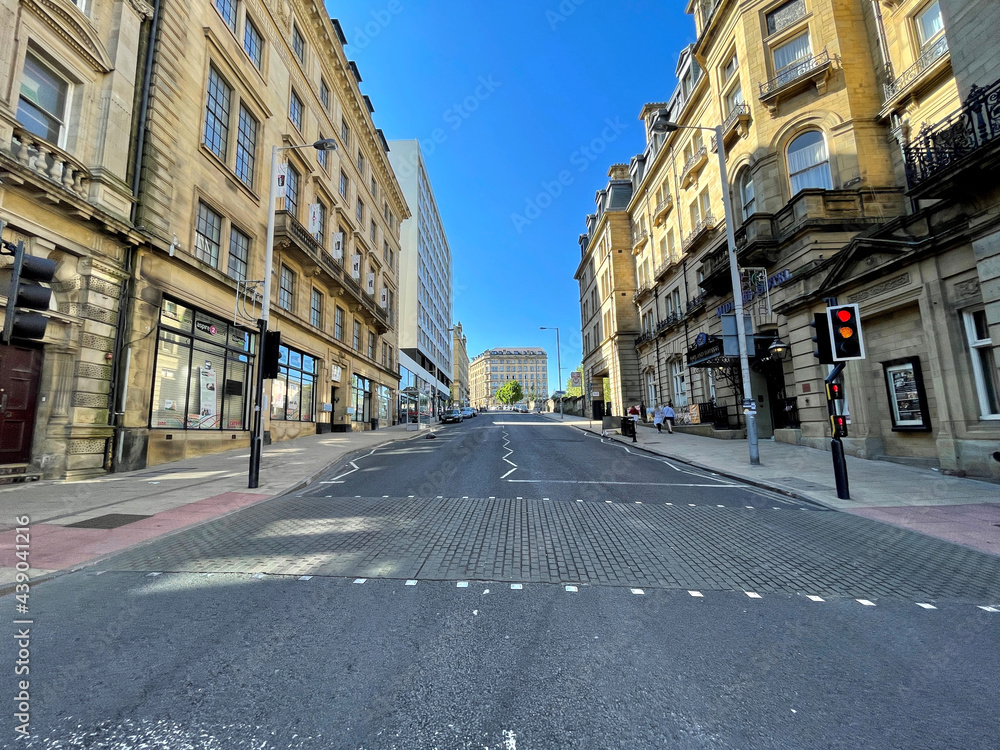Looking up, Cheapside, with Victorian stone buildings, set against a blue sky, in the post industrial city of, Bradford, Yorkshire, UK