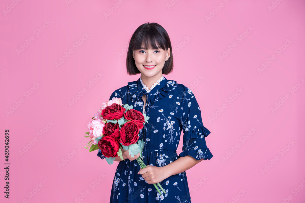 Asian woman happy smiling portrait holding large bouquet of red rose flowers gift pleasant surprise celebration valentine’s day mother’s day representing love care pink isolated wearing casual dress Asian woman happy smiling portrait holding large bouquet of red rose flowers gift pleasant surprise celebration valentine’s day mother’s day representing love care pink isolated wearing casual dress