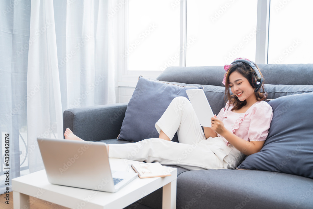 Online class learn student studying lockdown quarantine homeschooling and distance learning education, Asian beautiful girl living room study at home using tablet technology video call talking headset Online class learn student studying lockdown quarantine homeschooling and distance learning education, Asian beautiful girl living room study at home using tablet technology video call talking headset