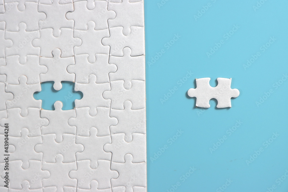 Jigsaw puzzle with missing piece. Missing puzzle pieces. Concept image of unfinished task. Completing final task, missing jigsaw puzzle pieces and business concept with a puzzle piece missing. blue Jigsaw puzzle with missing piece. Missing puzzle pieces. Concept image of unfinished task. Completing final task, missing jigsaw puzzle pieces and business concept with a puzzle piece missing. blue