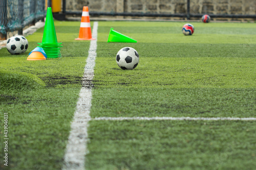 Soccer ball tactics on grass field with cone