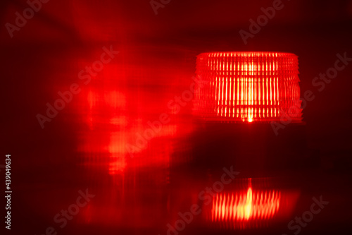 Close-up of flashing red emergency light at night