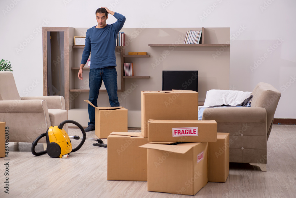 Young man moving to new flat Young man moving to new flat