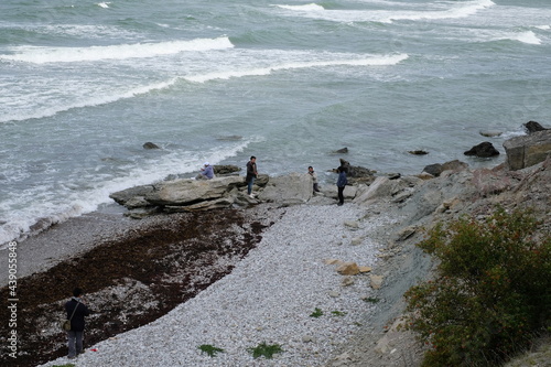 Beautiful beach with white sand, turquoise ocean, green palm trees and blue sky with clouds on Sunny day. Summer tropical landscape, panoramic view.
