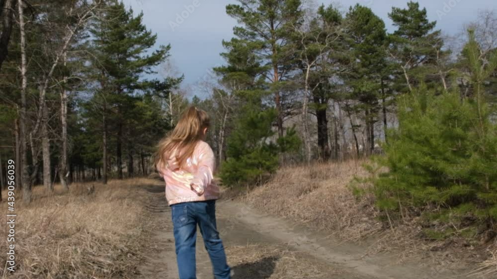 Having fun time. Child girl running along path in the forest, jumping and dancing, Active outdoor games. . Slow motion Having fun time. Child girl running along path in the forest, jumping and dancing, Active outdoor games. . Slow motion