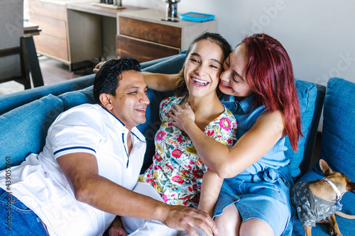 Hispanic family and disabled daughter with cerebral palsy having fun at home in disability concept in Latin America