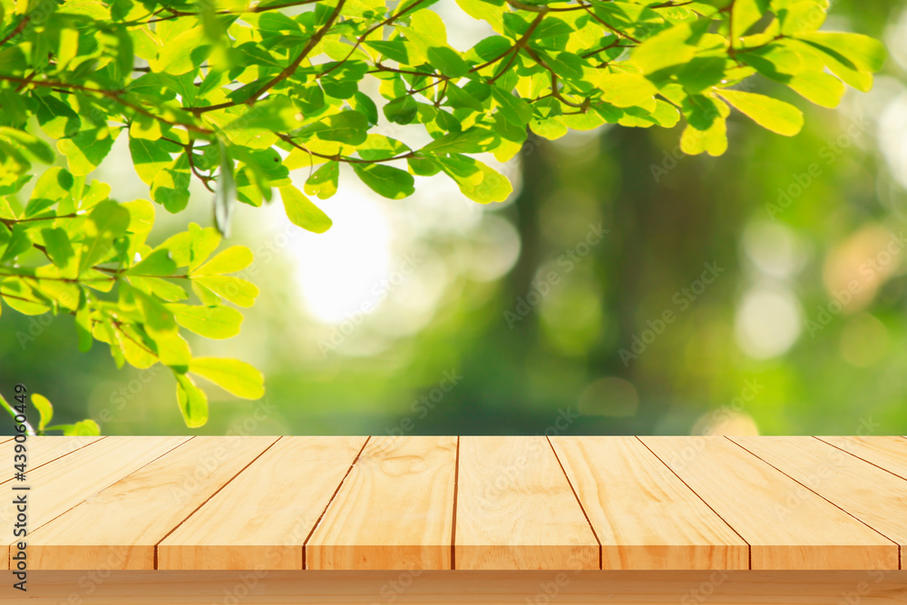 Wood floor with blurred trees of nature park background and summer season, product display montage Wood floor with blurred trees of nature park background and summer season, product display montage