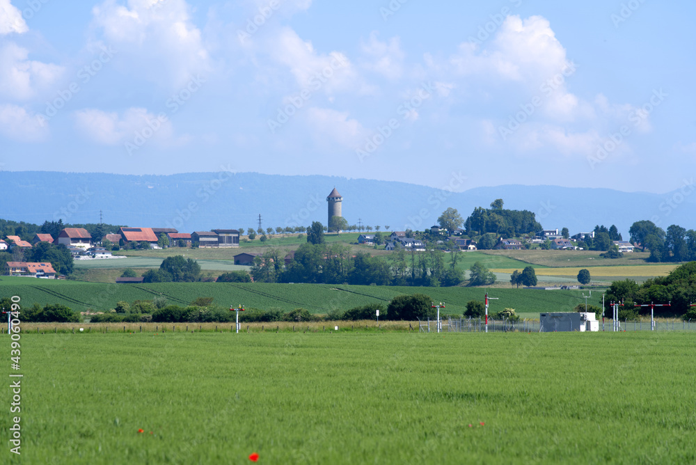 Φωτογραφία Landscape at the Swiss air force airbase at Payerne at summertime with water tower at village of Grandcourt in the background