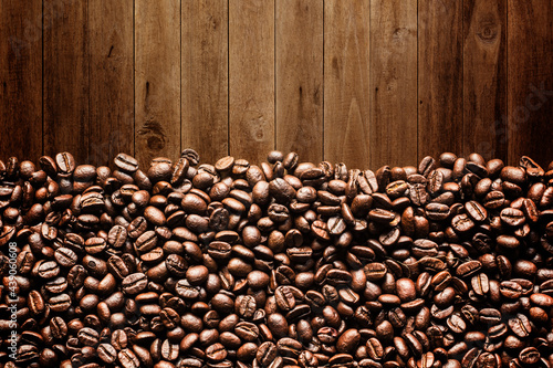 coffee beans on wooden background © saranyoo