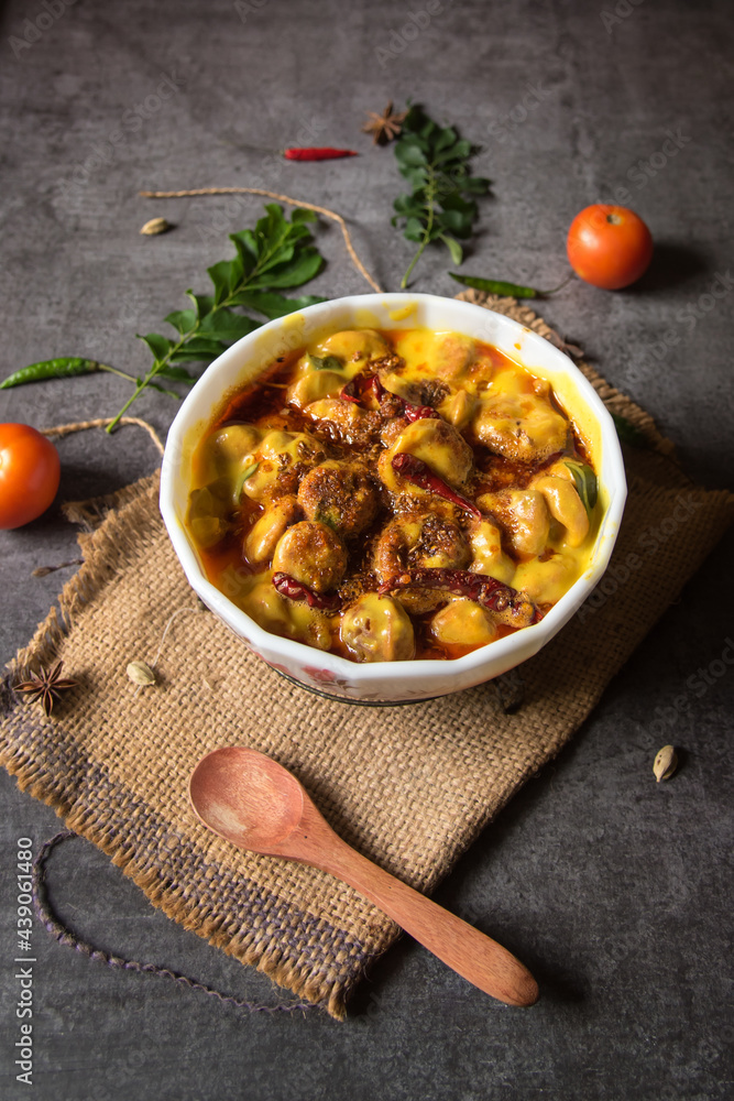 Fototapeta premium Karhi is a dish originating in Rajasthan, India. Made of thick gravy based on gram flour, and contains vegetable fritters called pakoras. A north Indian delicacy. Top view.