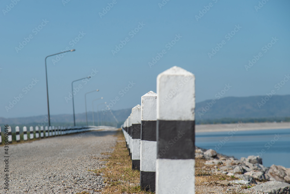 Selective focus on pillar Roadway in rural with a row of pillars black and white for travel concept idea