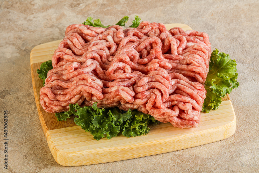 Raw pork minced meat over board Raw pork minced meat over board