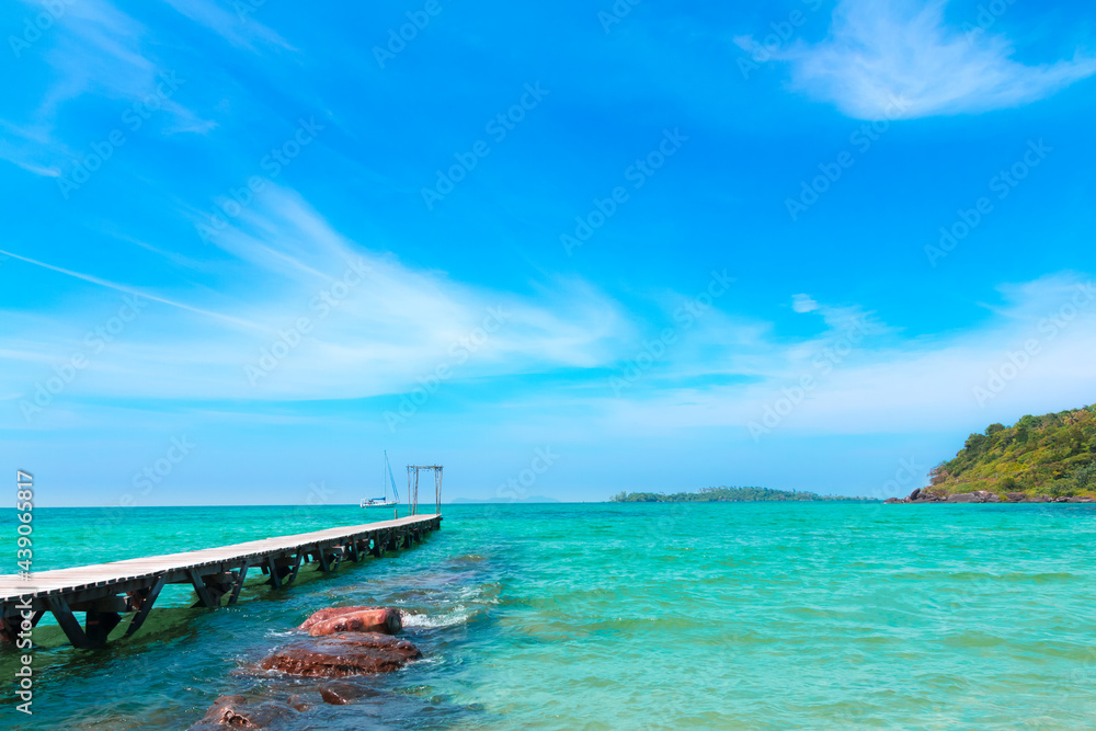 Landscape of seascape with wooden bridge in the sea at Koh Kood is a tropical island with emerald green water and beautiful beaches amidst clear blue sky.