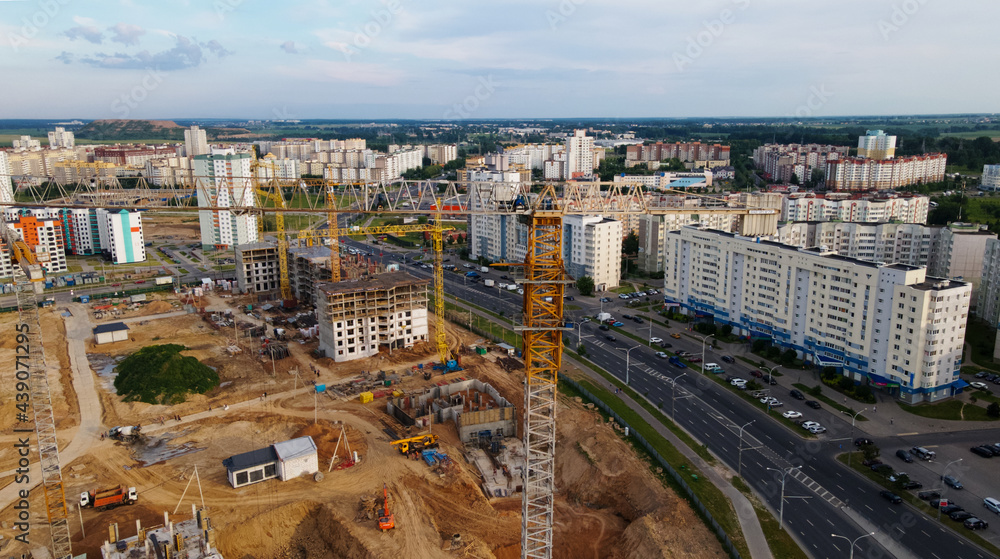 Aerial view of the new urban development. New houses are being built. The cranes are visible.