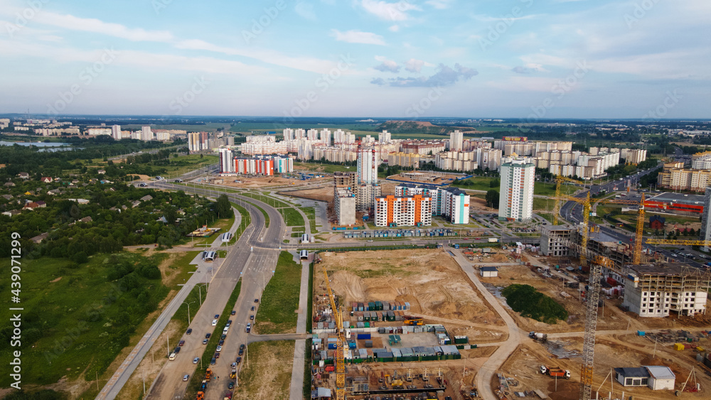 Obraz premium Aerial view of the new urban development. New houses are being built. The cranes are visible.