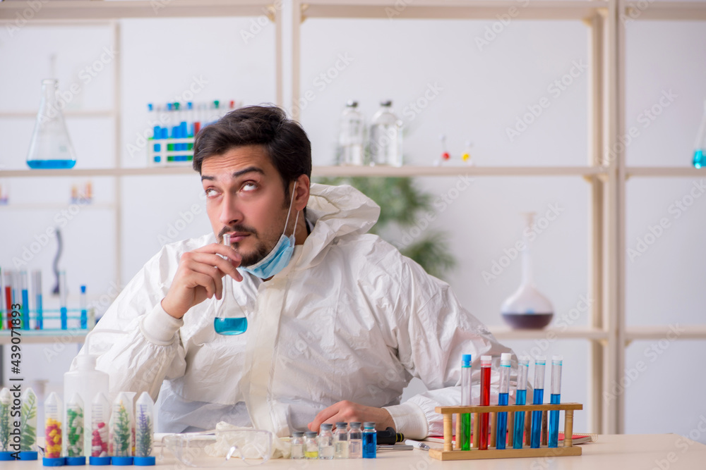 Young male chemist working at the lab during pandemic Young male chemist working at the lab during pandemic