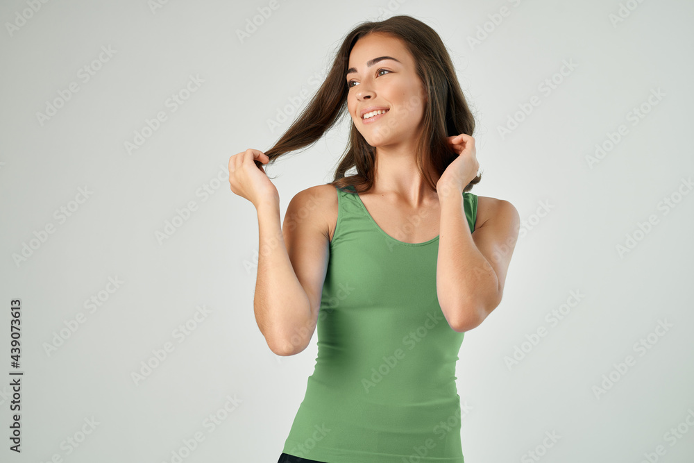 Fototapeta premium pretty brunette holding her hair fashion hairstyle care smile of the year
