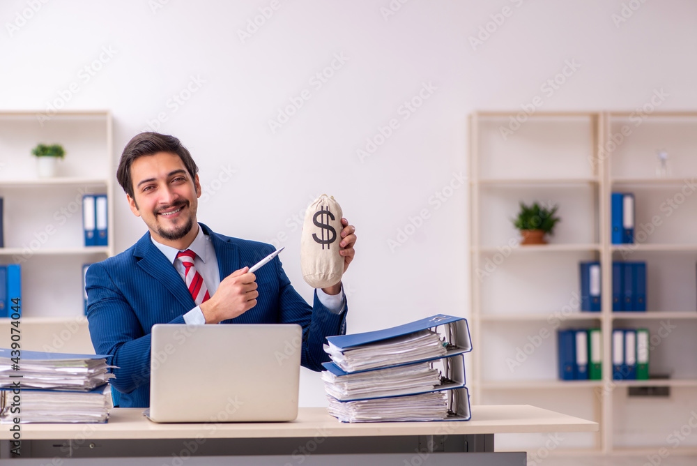 Young male employee unhappy with excessive work in the office