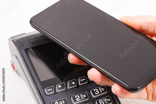Mobile phone or smartphone with payment terminal. Credit card reader. Cashless paying for shopping. Finance concept