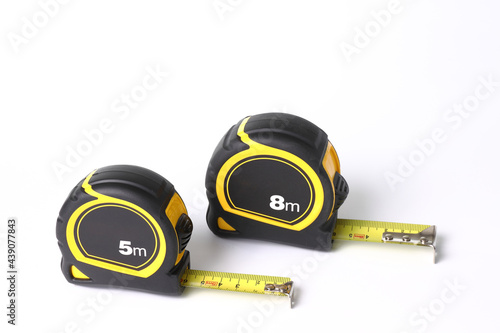 Flexometers or measuring tapes on white background photo