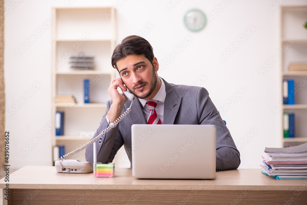 Young businessman employee working in the office Young businessman employee working in the office