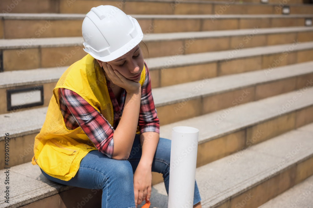 Tired female engineer sleep on stair at site