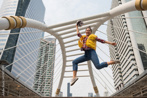 Smiling American engineer jump in city