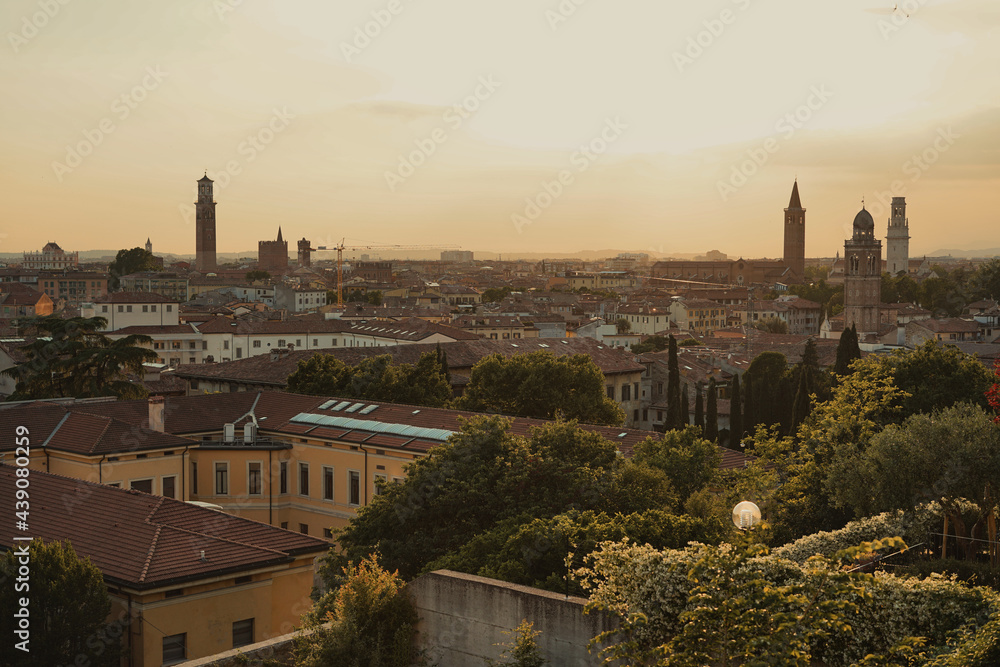 Overview of Verona, Italy. Panoramic photo of the city of Romeo and Juliet under a romantic pink sunset. Bell towers of the main Cathedral, San Giorgio, Santa Anastasia and Torre dei Lamberti.