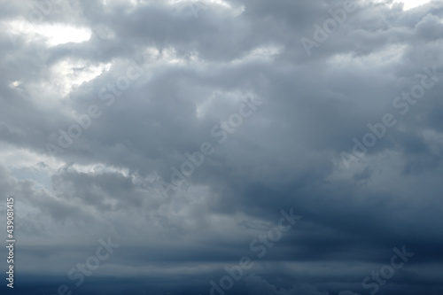 Dark sky full of clouds before the rain. Rain clouds and contrasting sunshine. Rain clouds.