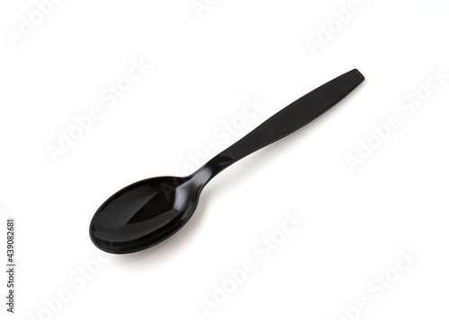 Black color plastic spoon isolated on white background.