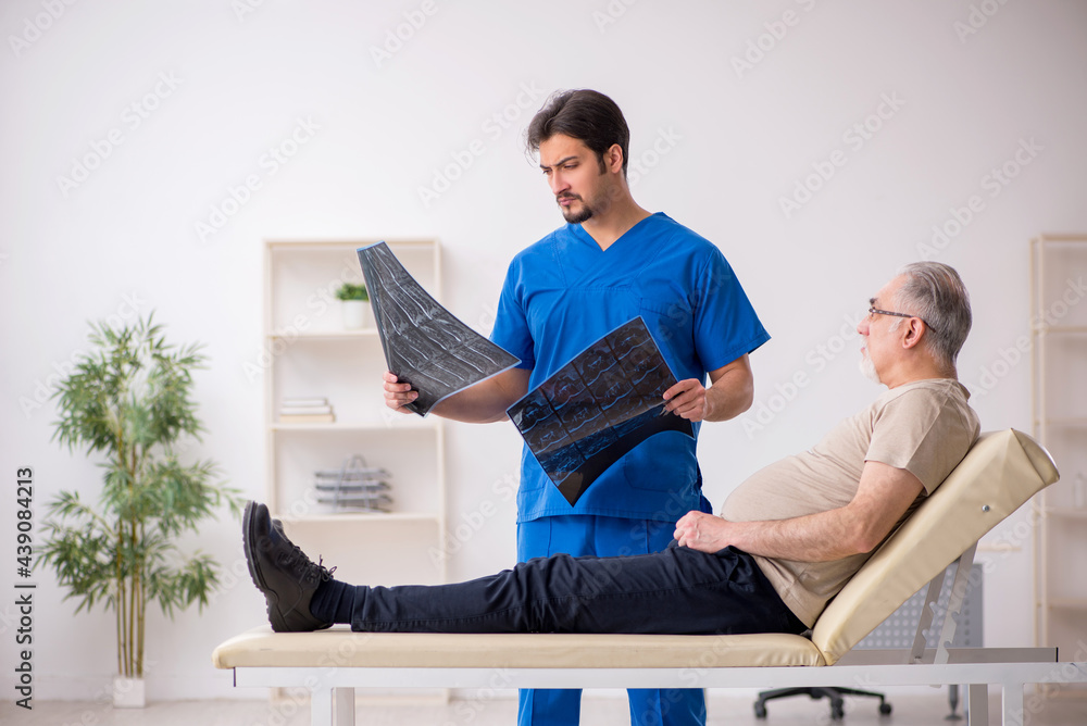 Old male patient visting young male doctor radilogist Old male patient visting young male doctor radilogist