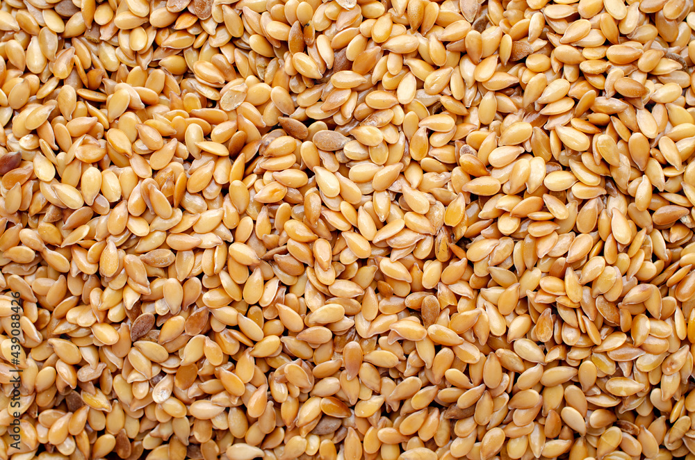 Top view of dry golden flax seed background Top view of dry golden flax seed background