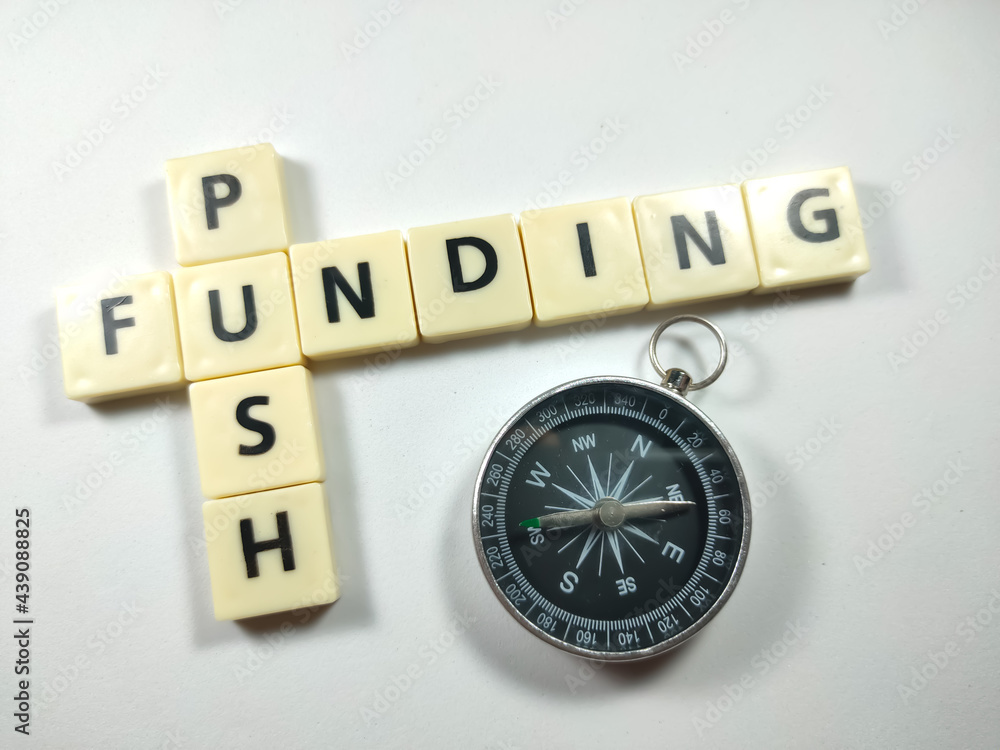 Selective focus.Scrabble letters with text PUSH FUNDING and compass on white background. Selective focus.Scrabble letters with text PUSH FUNDING and compass on white background.