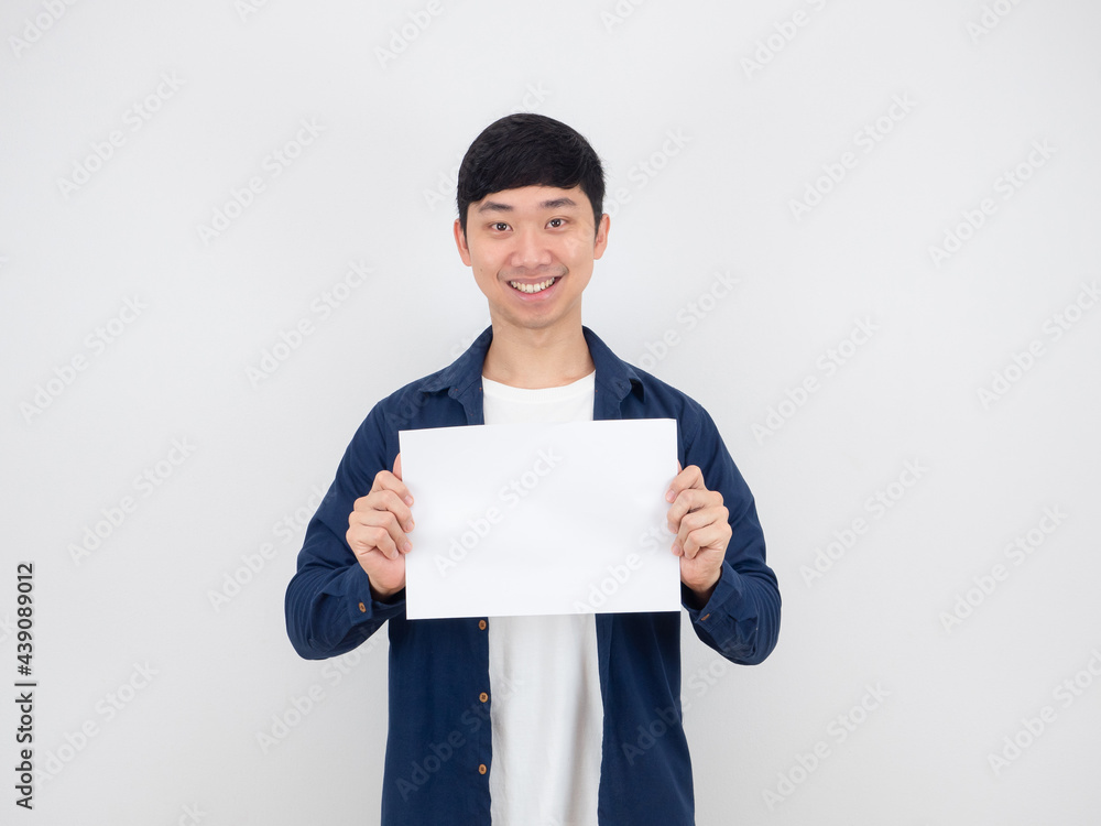 Asian man holding empty paper with happy smile at his face on white background Asian man holding empty paper with happy smile at his face on white background