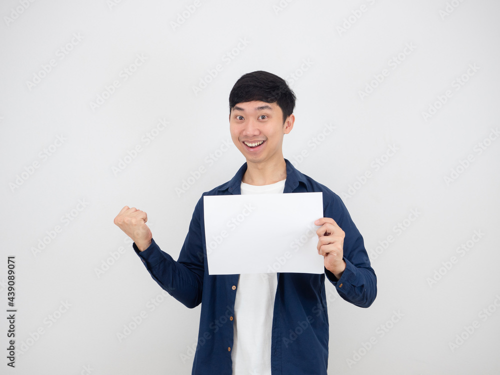 Cheerful man holding empty paper in hand and fist up with happy face and smile on white isolated background Cheerful man holding empty paper in hand and fist up with happy face and smile on white isolated background